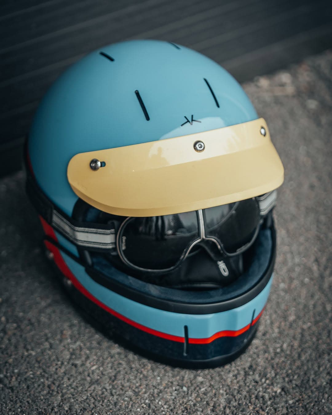Blue Veldt modular helmet with an amber peak and riding glasses